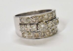 A white metal diamond set ring, the central stone approx 0.50ct, set with twenty smaller stones,