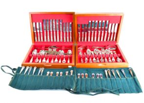 Two six setting cased canteens of silver plated cutlery and two fabric rolls of assorted silver