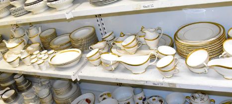 ROYAL DOULTON; an extensive tea and dinner service decorated in the 'Royal Gold' H.4980 pattern,
