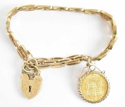 A yellow metal bracelet with yellow metal padlock clasp, mounted with a Victorian 1887 half shield