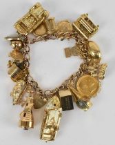 A 9ct yellow gold charm bracelet with an Edward VII 1905 half sovereign charm, speedboat charm,