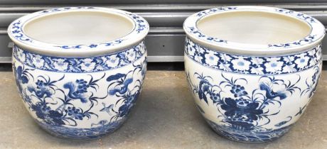 A pair of modern blue and white painted jardinières, diameter 36cm, height 29cm.