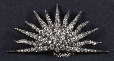 A 1930s Art Deco white metal diamond set sunburst brooch, the central stone weighing approx 0.75ct