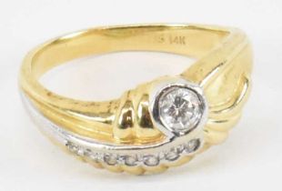A 14ct yellow gold ring set with central diamond and seven small stones, size L/M, approx 4.3g.