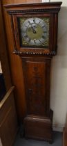 An early 20th century oak cased longcase clock, the brass face set with silvered chapter ring with