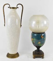 An early 20th century porcelain hand painted oil lamp with foliage decoration, mounted on a bronze