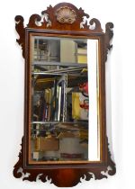 A reproduction Chippendale style mahogany fret carved wall mirror, height 104cm.