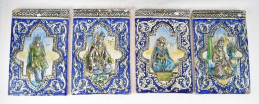 A set of four 18th/19th century large Persian tiles with raised detail and each centred with a