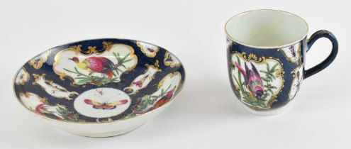 WORCESTER; a Dr Wall period teacup and saucer decorated with exotic birds and insects.