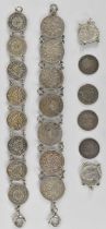 A silver sixpence bracelet, a silver threepence bracelet and eight loose silver threepence pieces.