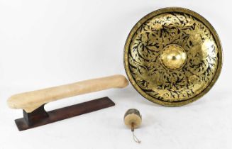 A large black lacquered and gilt decorated gong on stand, with mallet.