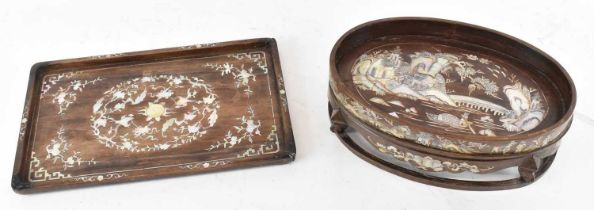 A Chinese carved hardwood and mother of pearl inlaid oval footed dish, decorated with scenes