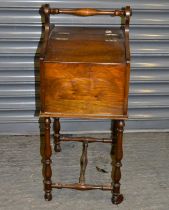 A reproduction mahogany sewing table, with twin hinged lid on turned supports, width 42.5cm,