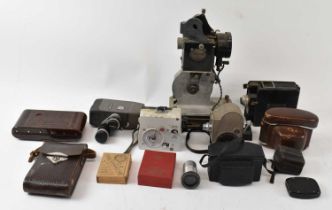 A quantity of cameras and photographic equipment, including a pathescope, a Canon Cine 8, a Kodak