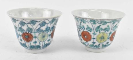 A pair of Chinese Republic period porcelain bowls, painted in enamels and decorated with lotus