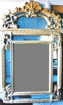 A reproduction overmantel mirror in the Rococo style, with open shell and scrolling fruit