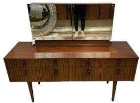 A mid 20th century teak dressing table, with open folding mirrors enclosing fitted interior above an