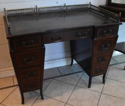 An Edwardian mahogany and satinwood crossbanded nine drawer pedestal desk with pierced brass