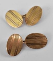 A pair of 9ct yellow gold oval cufflinks, combined approx 11.8g.