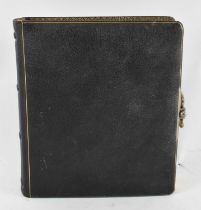 A 19th century leather bound photograph album containing a selection of family photographs.