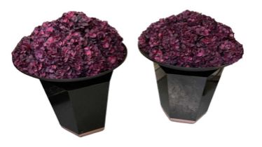 A pair of modern flower displays on black plinth bases, diameter approx 75cm, height approx 80cm.