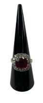 A yellow metal red stone and diamond cluster ring, the central ruby approx 3ct, surrounded by