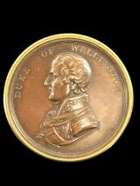 THE FIRST DUKE OF WELLINGTON (1769-1852); a copper effect box modelled as a coin, with gilt edges,