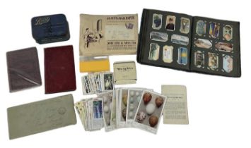 Two albums of 19th century and later cigarette cards and other loose cigarette cards in tins and