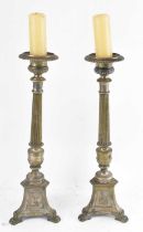 A large pair of silver plated candlesticks with figural decoration to the base, height 55cm.