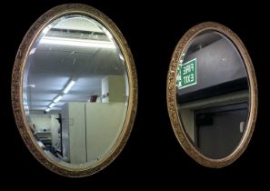 A pair of late 19th century gilt framed oval wall mirrors, height 70cm.