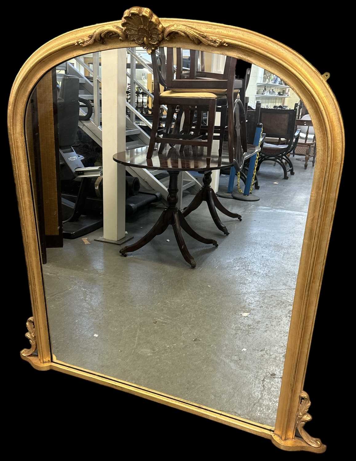 A reproduction gilt framed overmantel wall mirror, width approx 135cm, height 140cm.