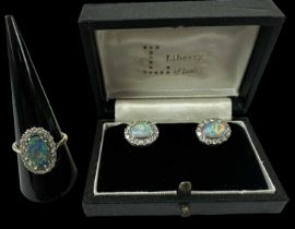 An 18ct yellow gold opal and diamond set ring, the central opal surrounded by twenty small diamonds,