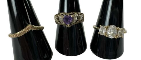 A 9ct yellow gold amethyst set ring, size P, a 9ct yellow gold ring set with three large white