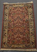 A red ground Super Kashan carpet with cream ground border, 177 x 91cm.