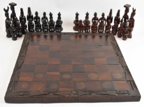 A hand carved wooden chess set in the Maasai style, with board.