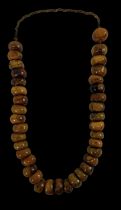 A strand of butterscotch amber beads, length approx 72cm.