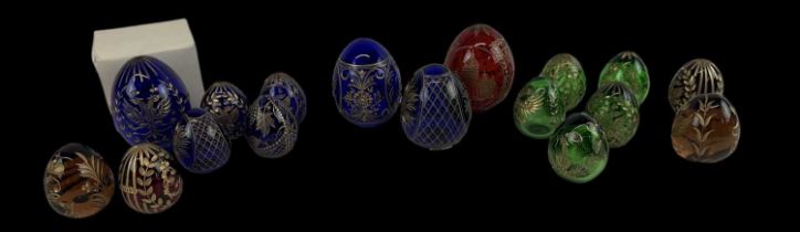 An interesting collection of seventeen Russian glass eggs, each with engraved gilt heightened