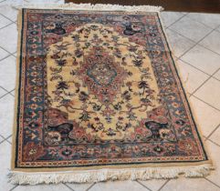 A Persian red and cream ground carpet with floral decoration, 180 x 122cm.
