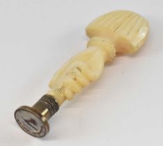 A 19th century mother of pearl carved desk seal modelled as a hand, height 7.5cm.