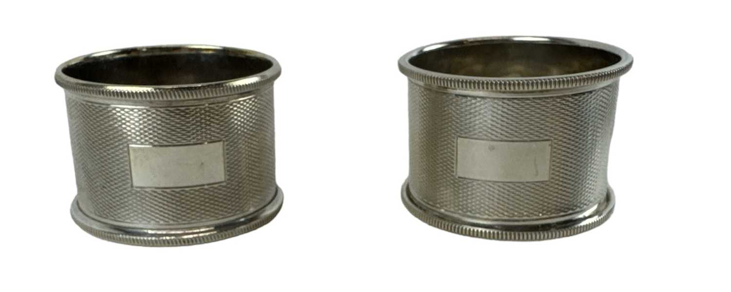 TURNER & SIMPSON LTD; a pair of hallmarked silver napkin rings, Birmingham 1964, combined approx 1.