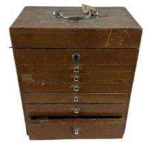 A mid century six drawer doctor's box, with hinged lid, containing contents.