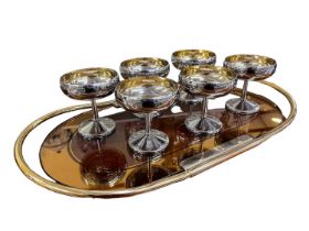 An Art Deco style peach glass oval twin handled tray, diameter 53cm, and a set of six silver
