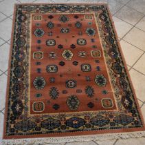 A Persian red ground carpet with geometric border, 181 x 119.5cm.