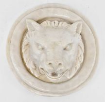 A decorative resin circular wall hanging modelled as a wolf's head, diameter 28.5cm.