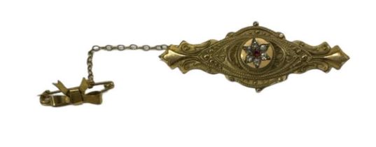 An Edwardian 9ct yellow gold ruby and diamond set brooch, suspended on yellow metal safety clasp,