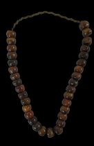 A strand of cherry amber beads, length approx 70cm.