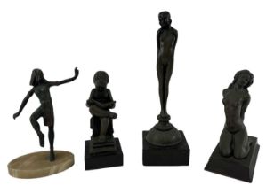 A group of four decorative resin figures including a figure of a kneeling nude female, height