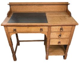 IN THE STYLE OF SHAPLAND & PETTER; an early 20th century light oak Arts and Crafts kneehole desk,