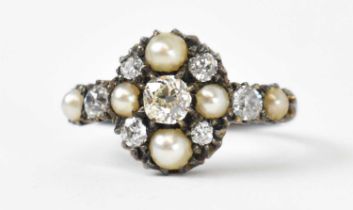 A white metal diamond and seed pearl set ring, the central stone approx 0.35ct, total diamond weight