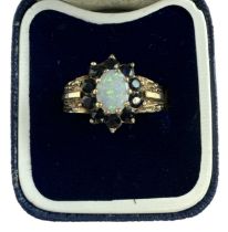 A 9ct yellow gold opal and garnet set ring, size O, approx 3g.